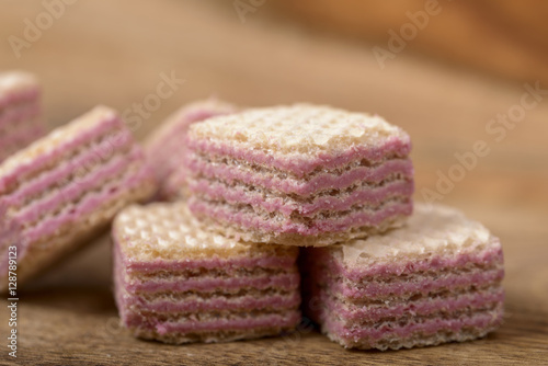 macro wafers stuffed with raspberry cream over wood