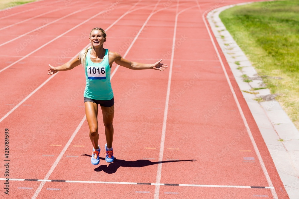 Excited female athlete posing after a victory Excited female athlete posing after a victory