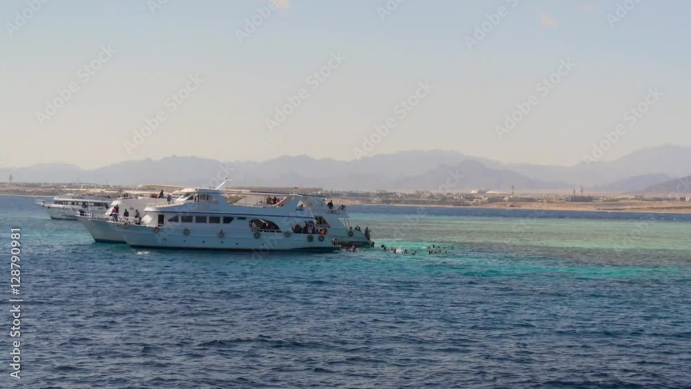 Red sea, cruise boat with tourists near coral reefs. Red sea, cruise boat with tourists near coral reefs.