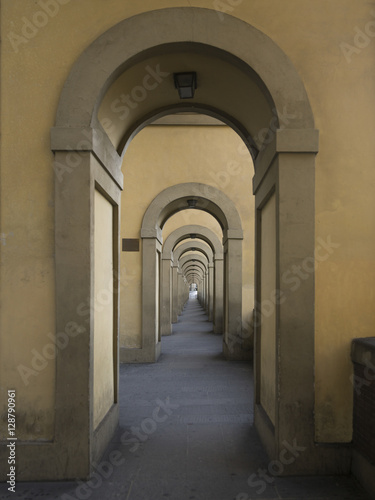Arched corridor on a building exterior. © klevit