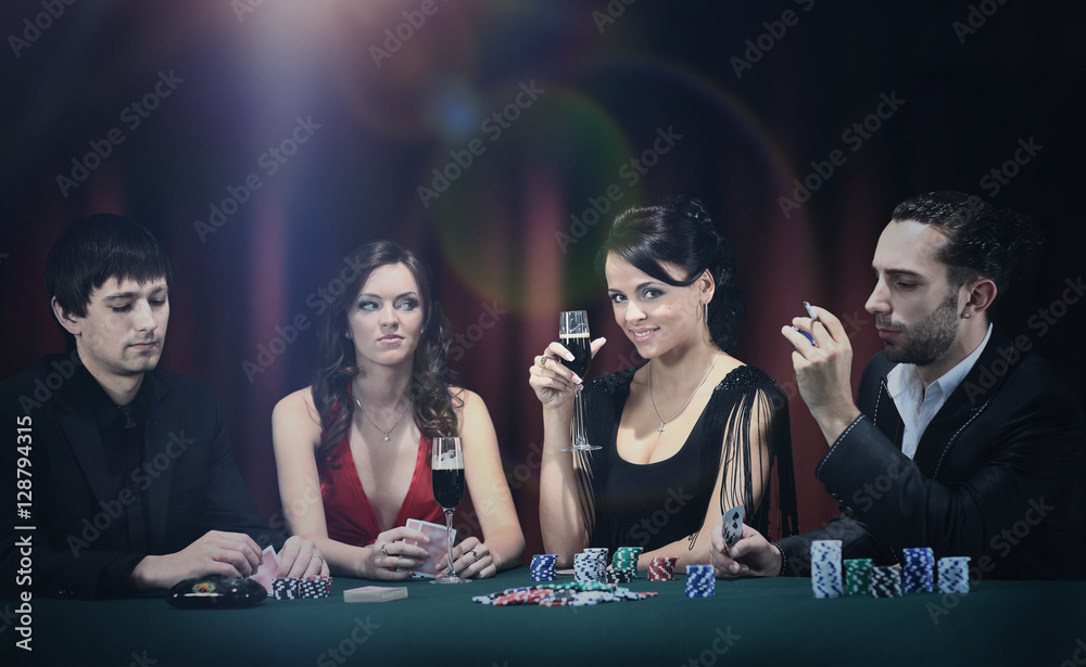Poker players sitting around a table at a casino Poker players sitting around a table at a casino