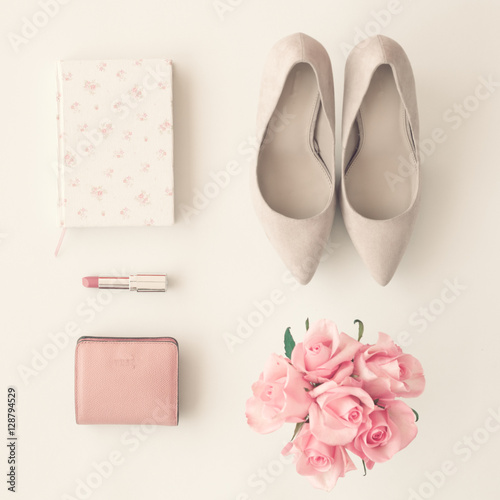 Heel shoes, notebook, lipstick, wallet and roses flat lay