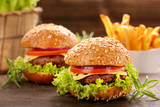 Hamburger with beef meat and fresh vegetables on wooden backgrou