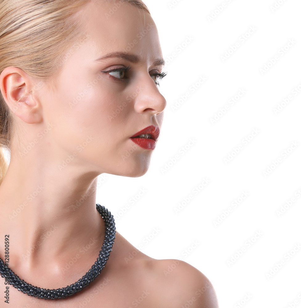 Young woman with stylish necklace on white background