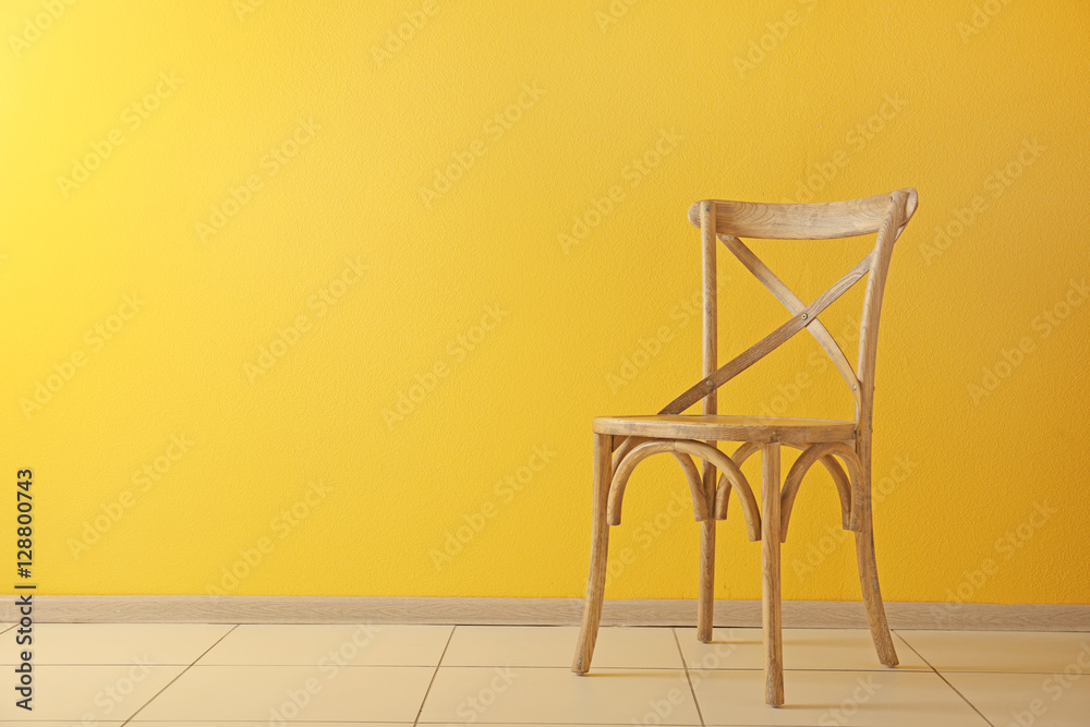 Stylish chair on yellow wall background Stock Photo | Adobe Stock