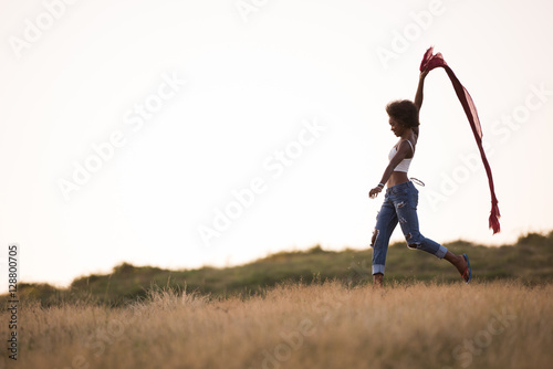 black girl dances outdoors in a meadow