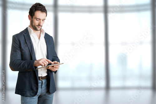 Casual Businessman Looking at a Tablet