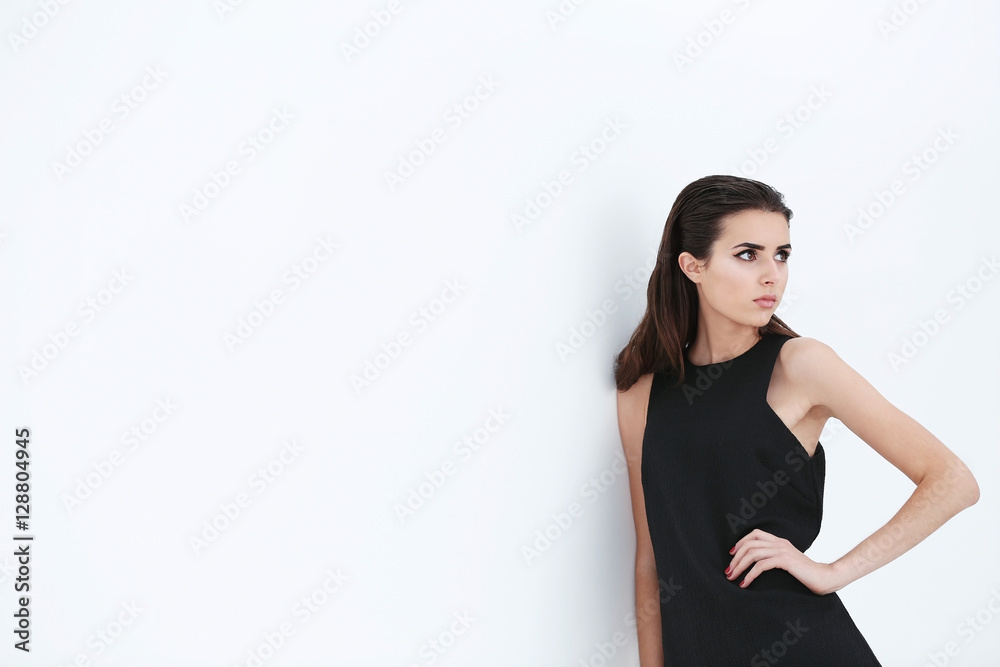 Beautiful woman in fashion clothes on color background Beautiful woman in fashion clothes on color background