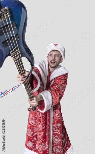 young man in the image of Santa Claus with a guitar in his hands
