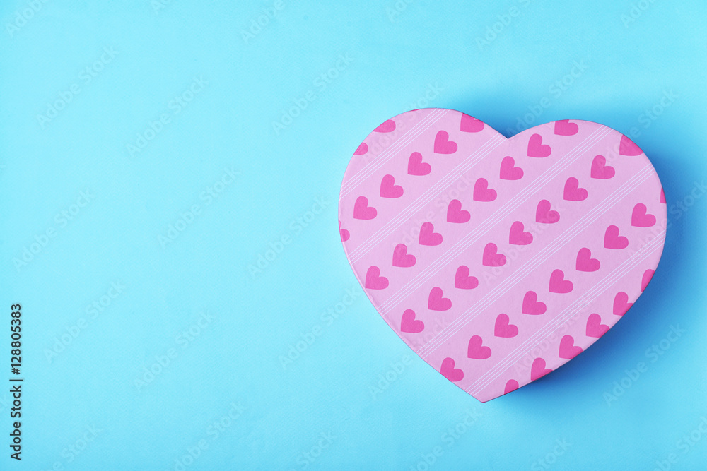 Heart shaped gift box on blue background Heart shaped gift box on blue background