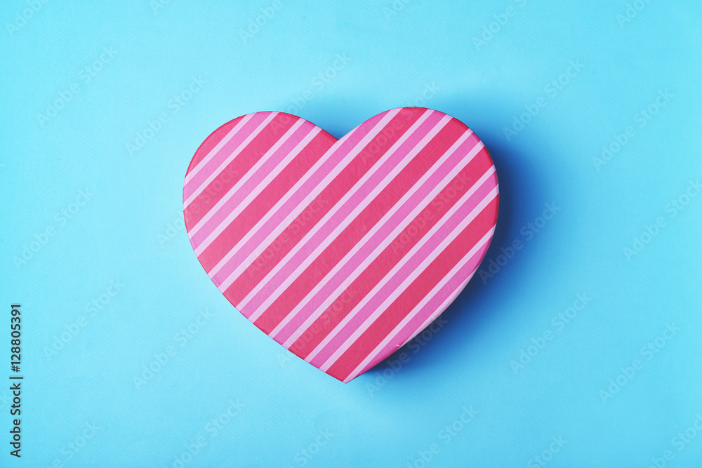 Heart shaped gift box on blue background Heart shaped gift box on blue background