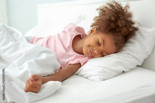 Photography Little African American girl resting in bed