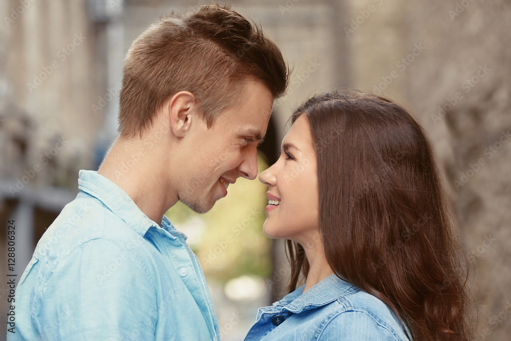 Portrait of beautiful young couple outdoors on blurred background Portrait of beautiful young couple outdoors on blurred background