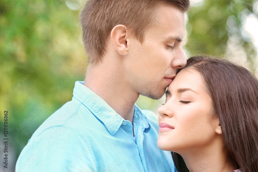 Portrait of beautiful young couple outdoors on blurred background Portrait of beautiful young couple outdoors on blurred background