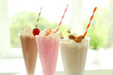 Delicious milkshakes on blurred background