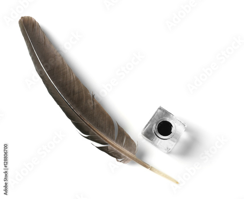 Feather pen and inkwell isolated on white