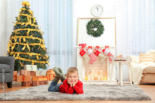 Cute little boy lying on ca...