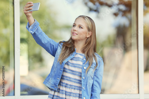 Pretty teenager girl taking...