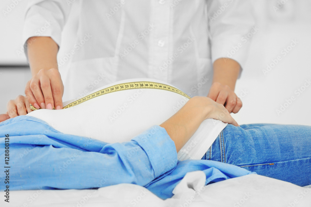 Doctor measuring pregnant belly