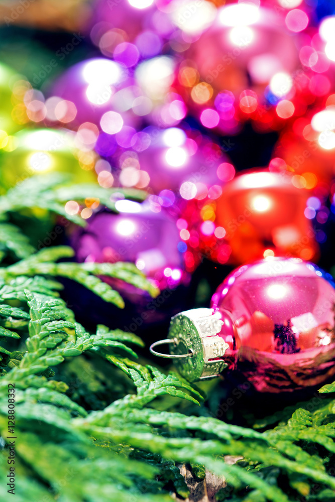 Multi-colored Christmas toys and Christmas tree closeup Multi-colored Christmas toys and Christmas tree closeup