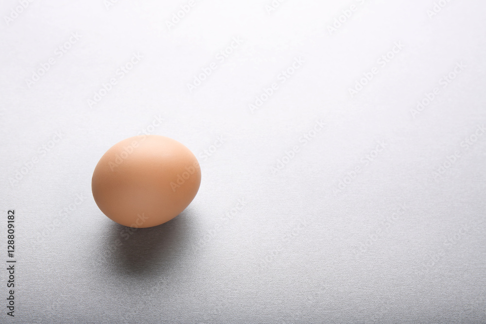 Raw egg on grey background Raw egg on grey background