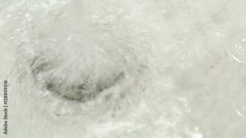 Closeup of kitchen sink plug as basin is filled with water Closeup of kitchen sink plug as basin is filled with water