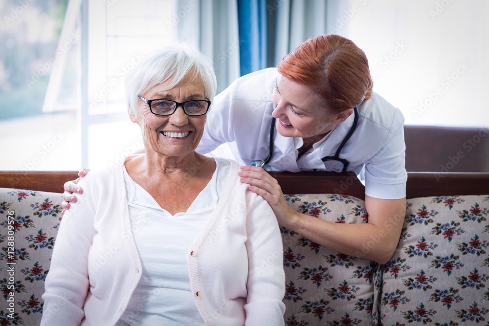 Fototapeta premium Doctor consoling senior woman