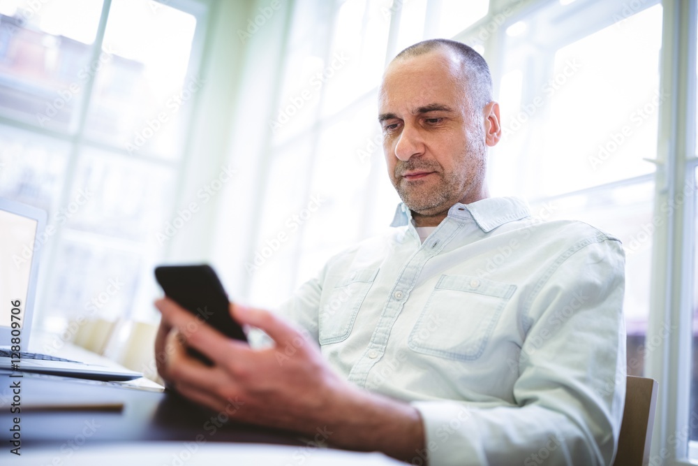 Serious businessman using mobile phone Serious businessman using mobile phone