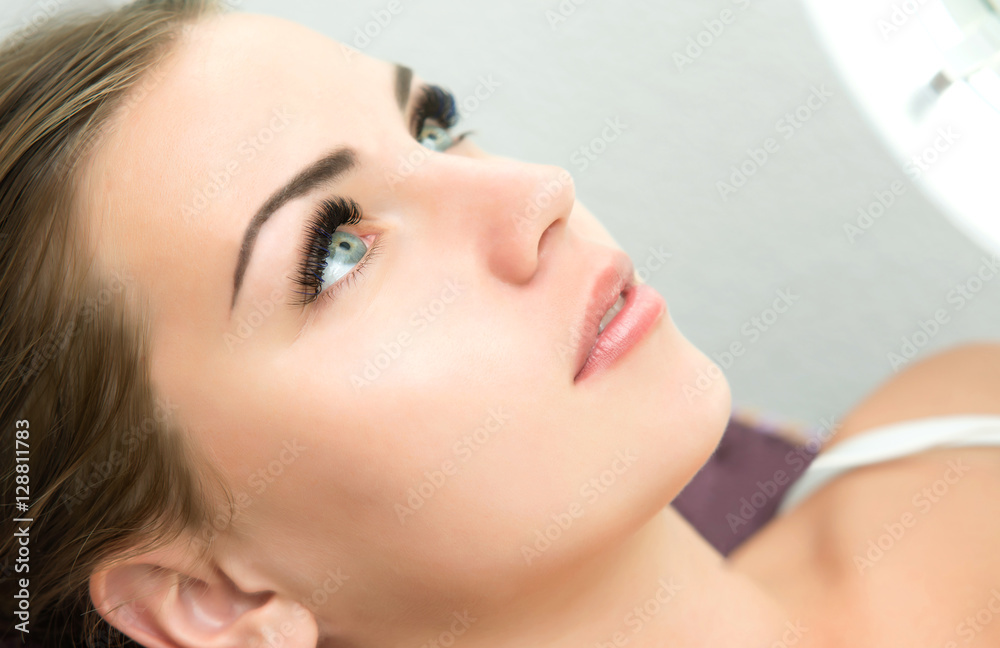 Eyelash Extension Procedure.  Woman Eye with Long Eyelashes.