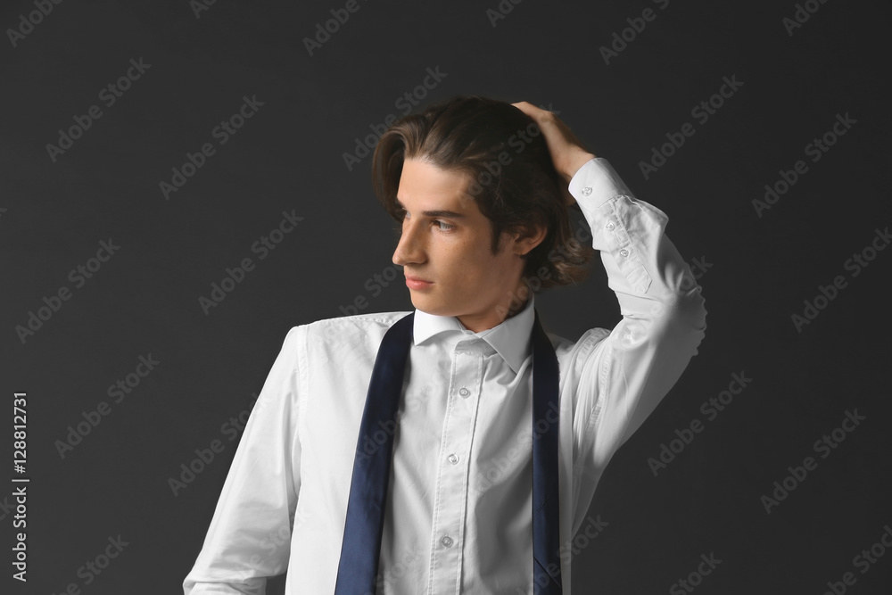 Handsome young man on dark background