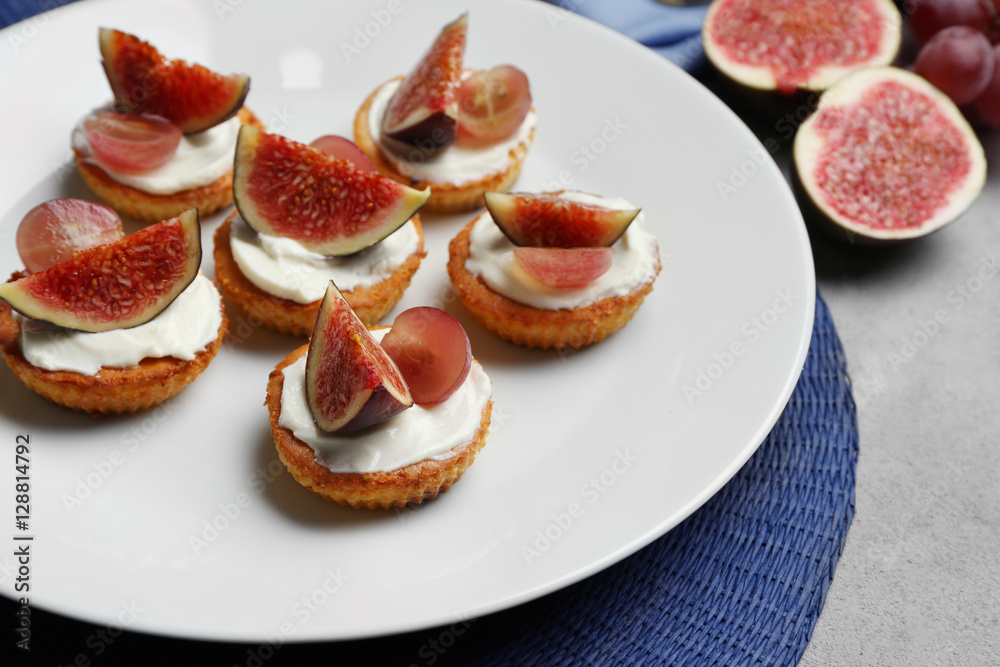 Delicious fig tarts on plate, closeup Delicious fig tarts on plate, closeup
