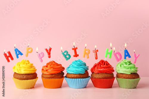 Happy birthday cupcakes on pink background