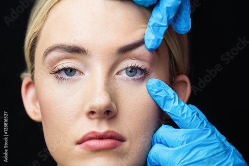 Woman has an examination of her skin before botox injection