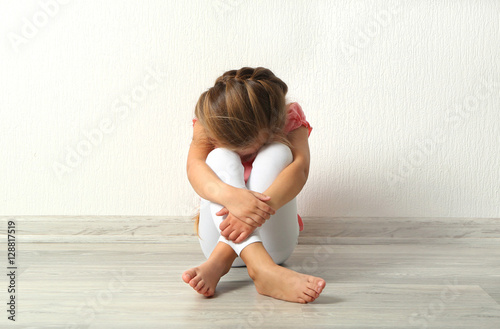 Sad little girl sitting on ...