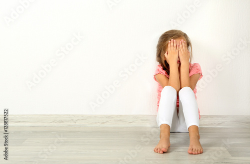 Crying little girl on floor...