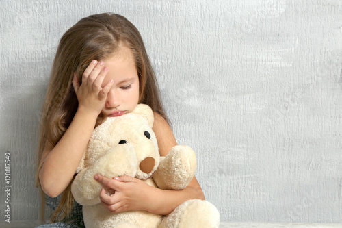 Sad little girl with teddy ...