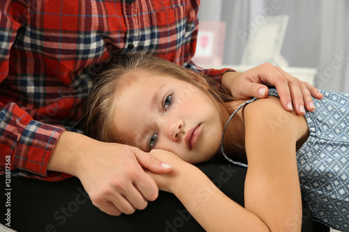 Cute little girl putting he...