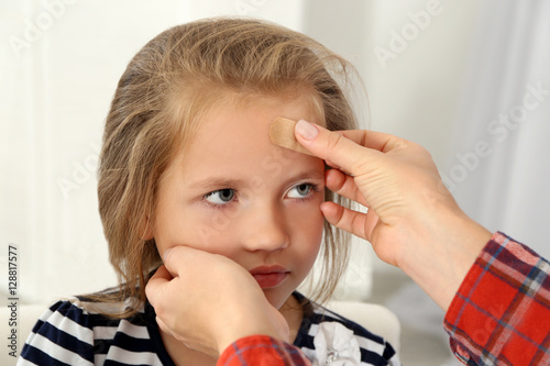 Woman applying sticking pla...