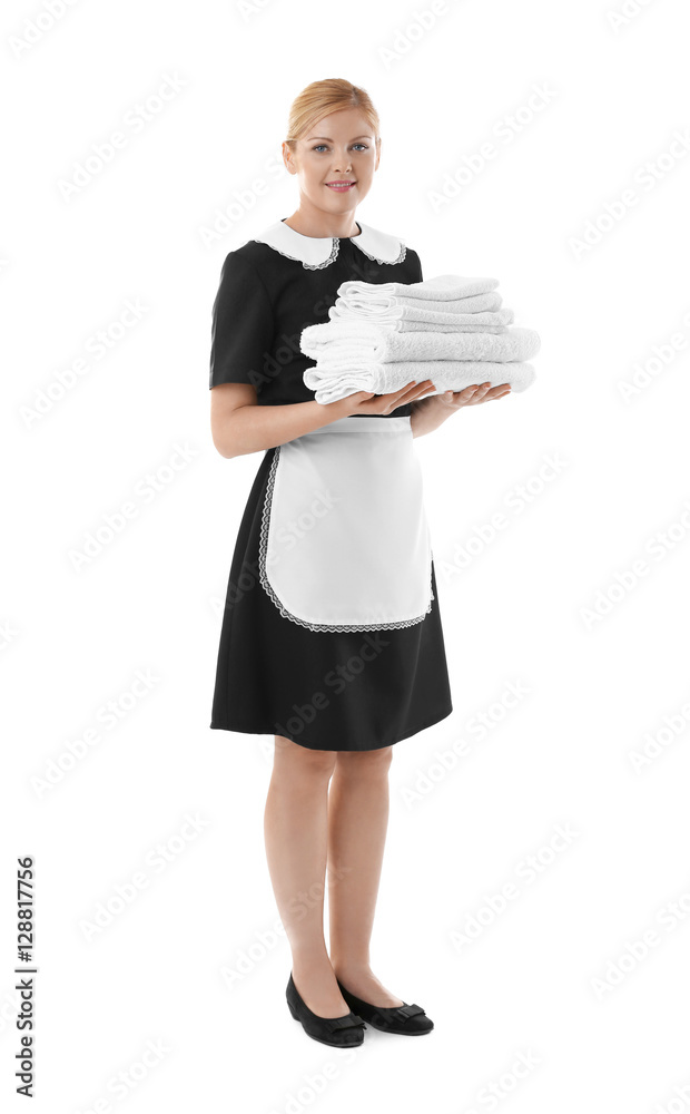 Beautiful chambermaid holding pile of clean towels on white background Beautiful chambermaid holding pile of clean towels on white background