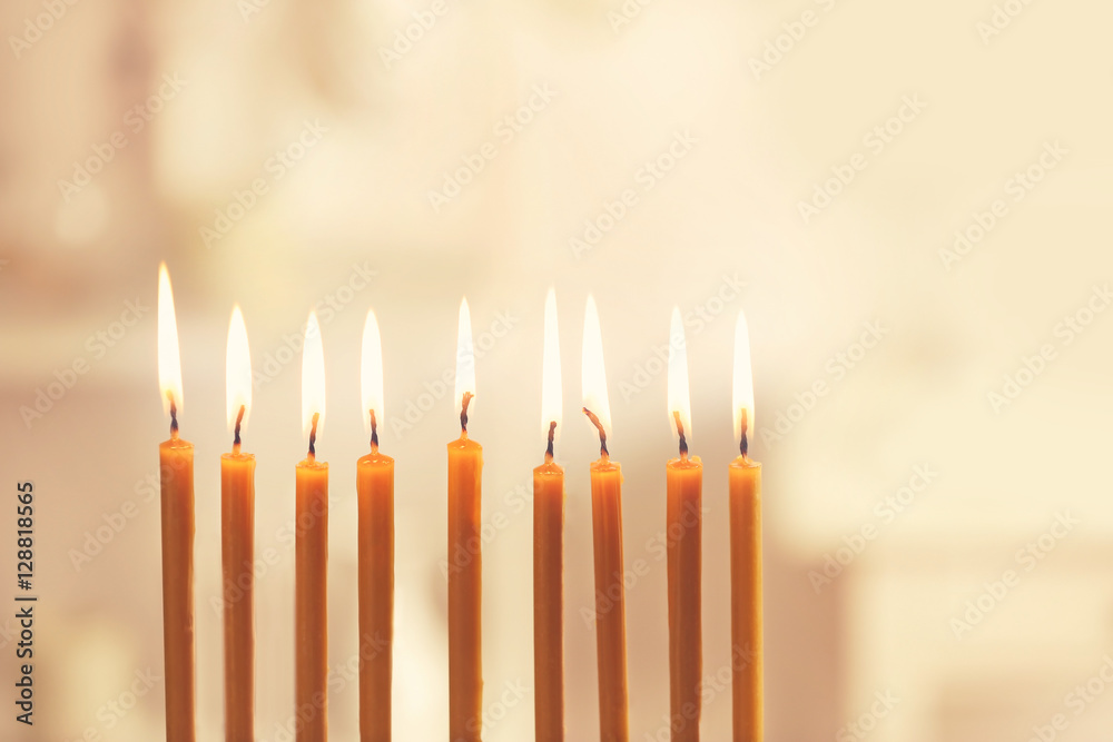 Nine burning candles on blurred background. Hanukkah concept Nine burning candles on blurred background. Hanukkah concept