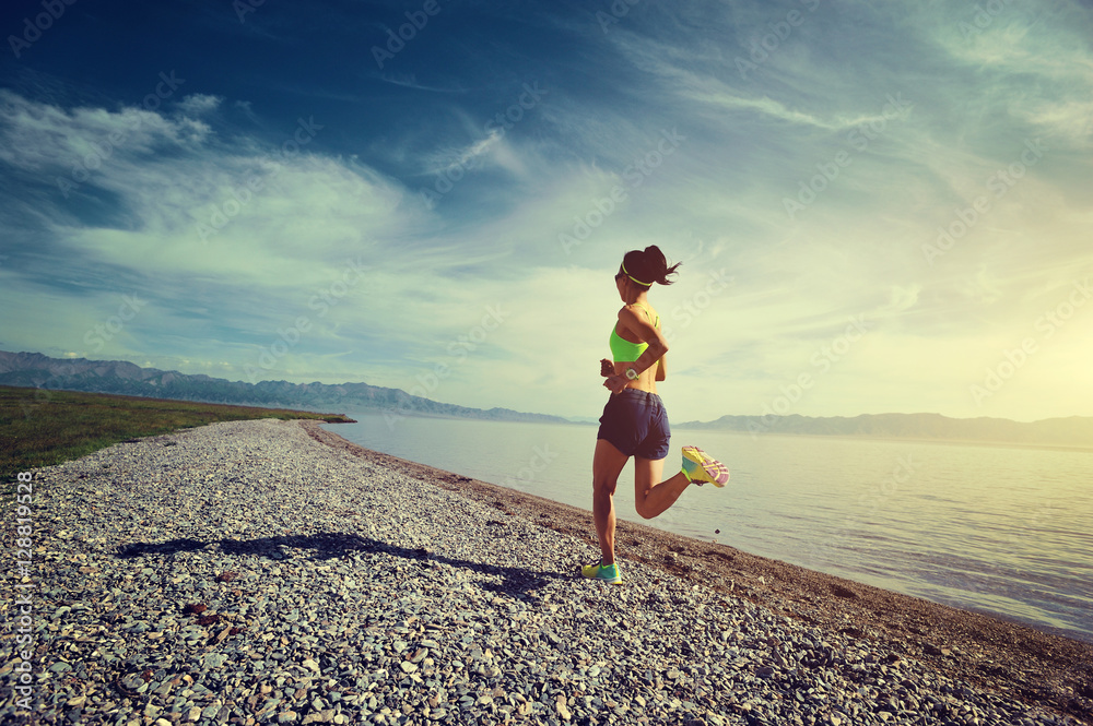 young fitness sports woman trail runner running on seaside