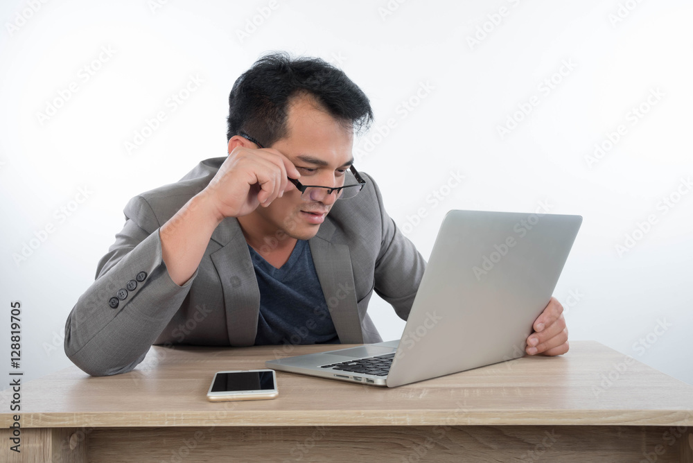 young businessman Stressful jobs using a laptop sitting thinking young businessman Stressful jobs using a laptop sitting thinking