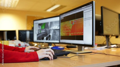 Woman's hand holding a mouse for office design work. Female architect or engineer designing building