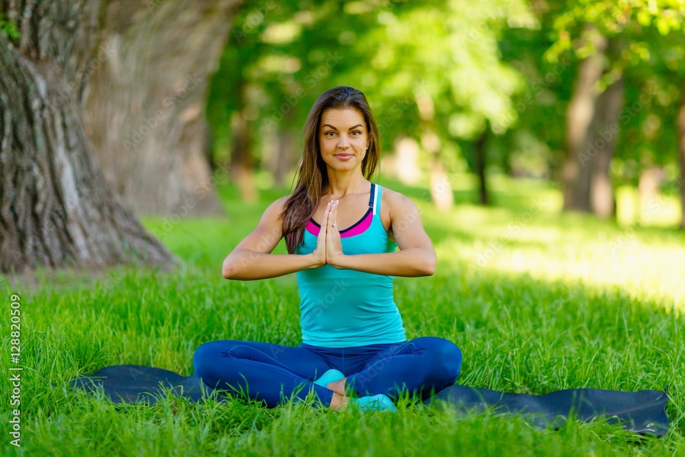 Yoga woman on green grass 
