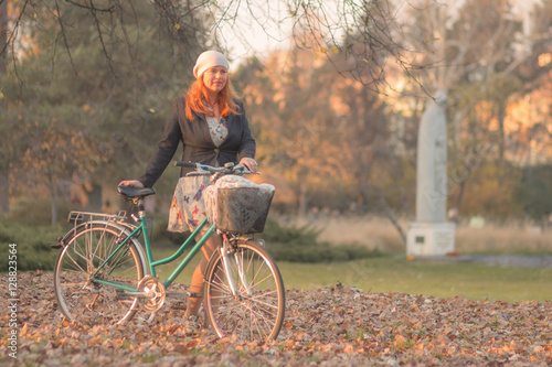 Young adult woman bicycle park autumn