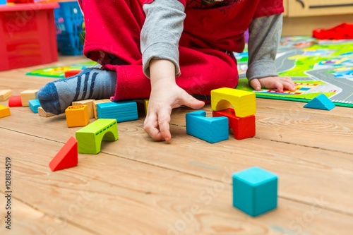 Small boy playing with wooden blocks