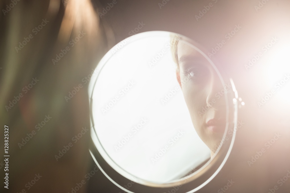 Portrait of a woman who is looking her in a mirror - obrazy, fototapety, plakaty 