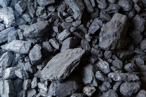Black coal lying on a pile in house basement