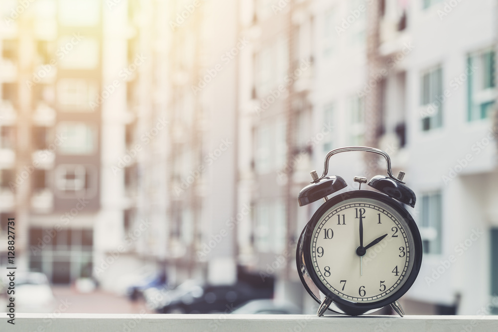 2 o'clock retro clock with The Clock condominium background. 2 o'clock retro clock with The Clock condominium background.