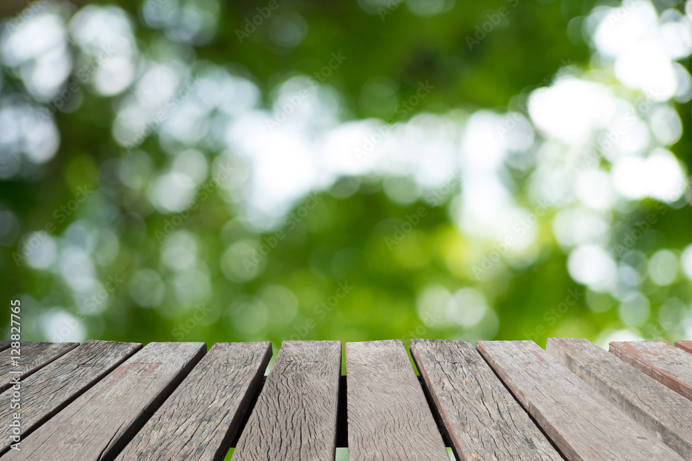 Wooden floor or wooden planks with blur image of light streaming through leaves. Wooden floor or wooden planks with blur image of light streaming through leaves.